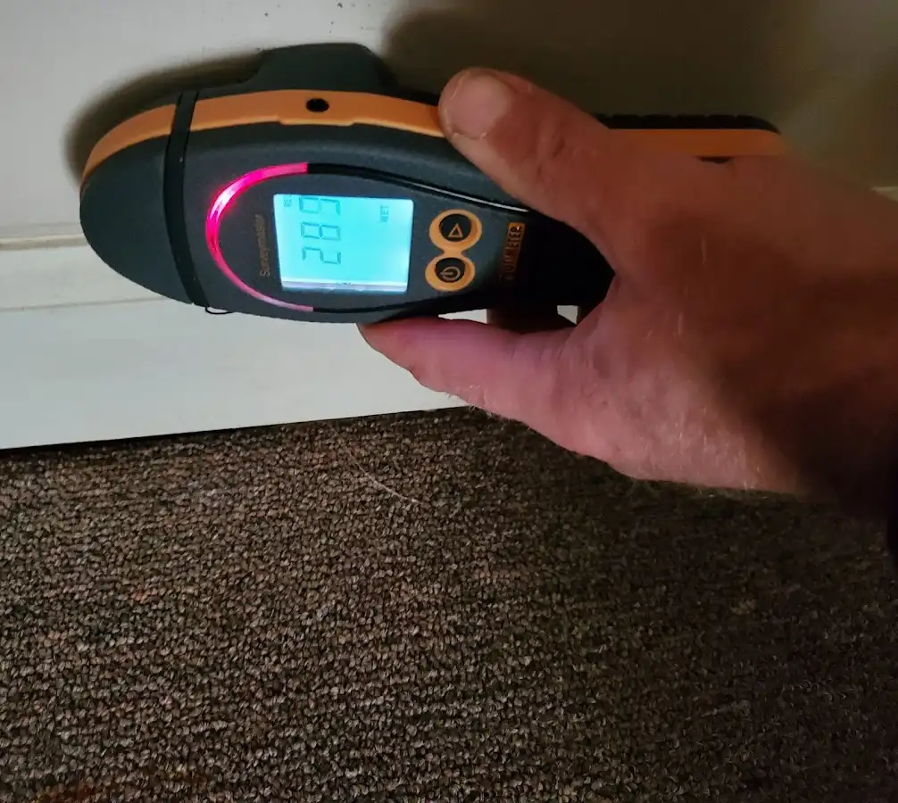 Moisture detection at baseboard during Storm Damage Restoration in Burton